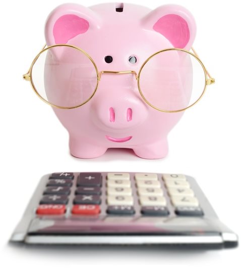 Tirelire cochon devant une calculette